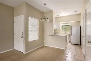 a kitchen with a refrigerator and a sink