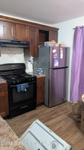 a kitchen with stainless steel appliances granite countertop a refrigerator stove and a sink