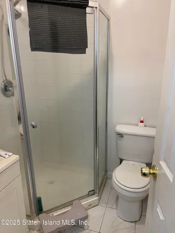 a bathroom with a toilet and a shower