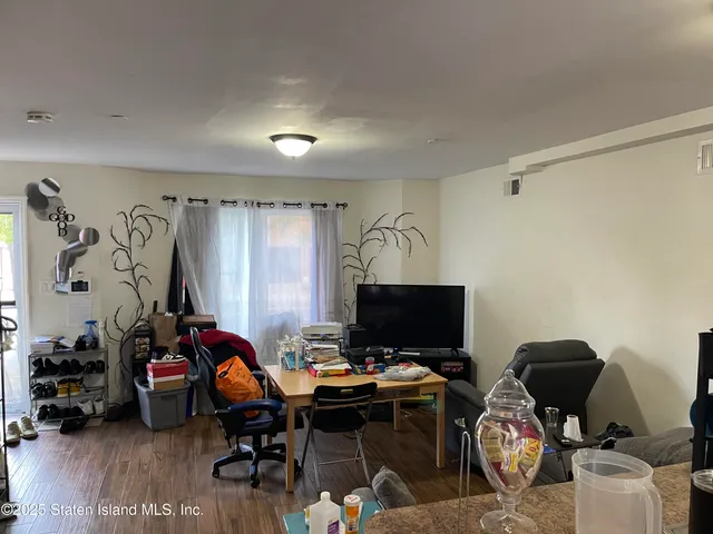 a view of a workspace with furniture and a gate