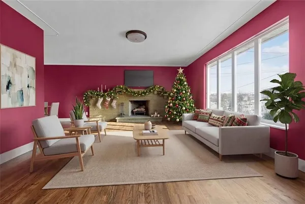 a living room with furniture fireplace and a large window
