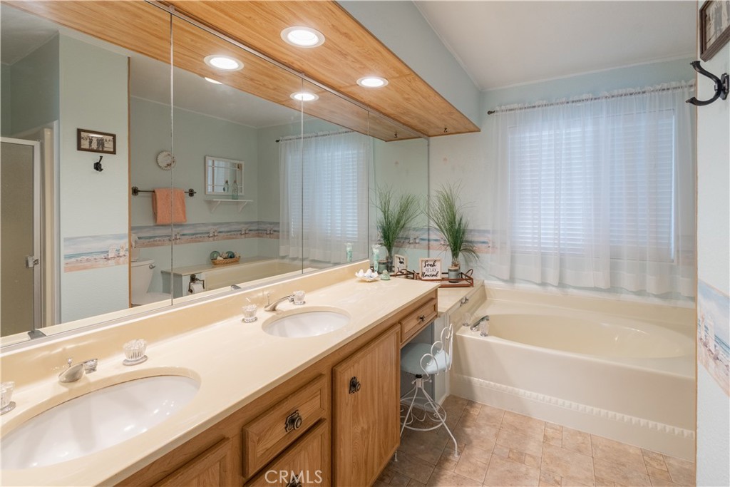 342 Bobwhite Drive Paso Robles, CA 93446 - Photo 12 of 35 a bathroom with a double vanity sink and a bathtub