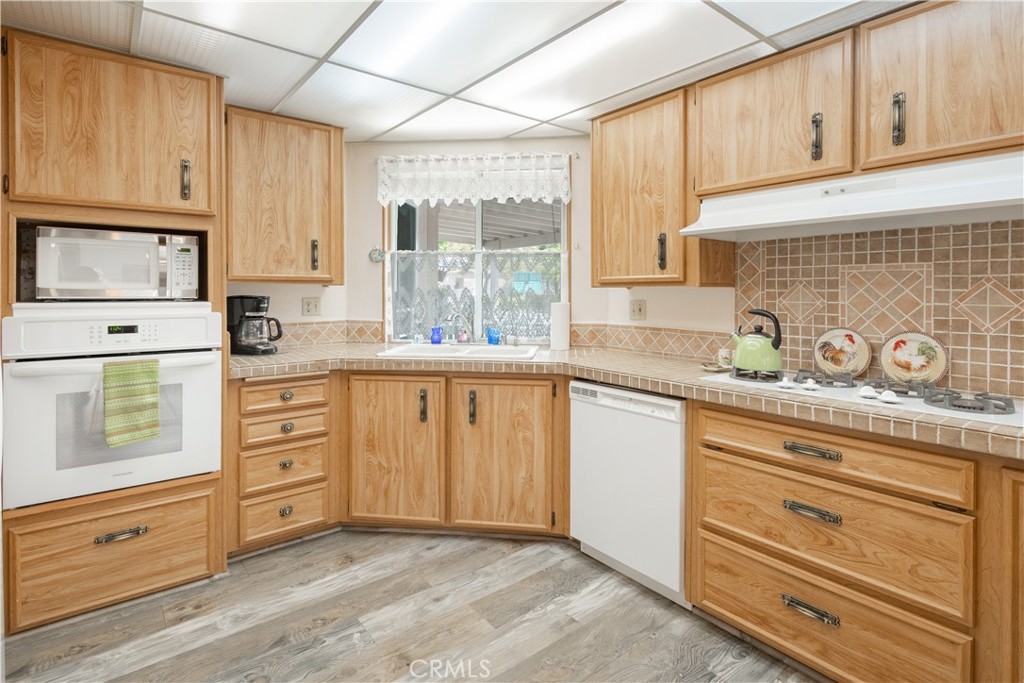342 Bobwhite Drive Paso Robles, CA 93446 - Photo 6 of 35 a kitchen with granite countertop white cabinets and stainless steel appliances