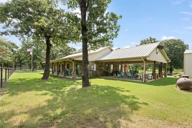 a view of a house with a yard porch and sitting area