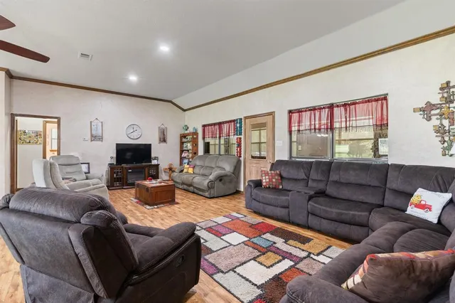 a living room with furniture ceiling fan and a rug