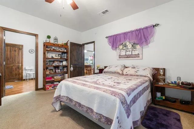a bedroom with a bed and a book shelf