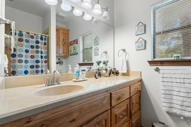 a bathroom with a sink a vanity and a mirror