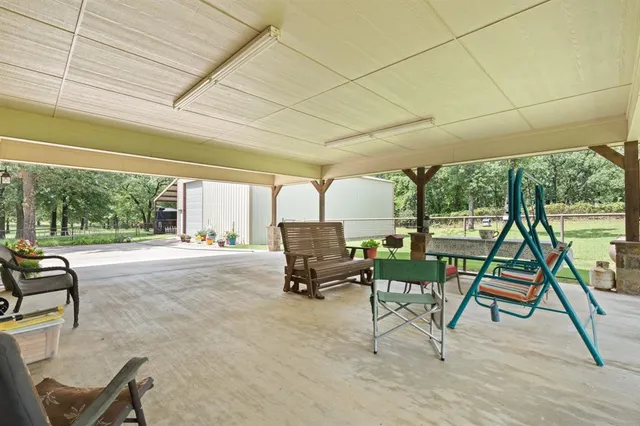 a living room with a patio furniture and a floor to ceiling window
