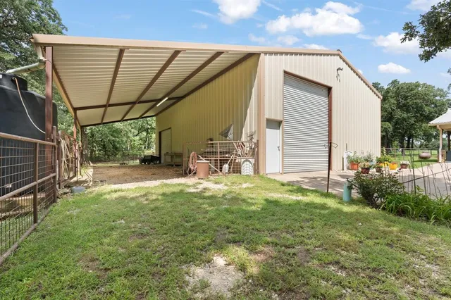 a backyard of a house with table and chairs