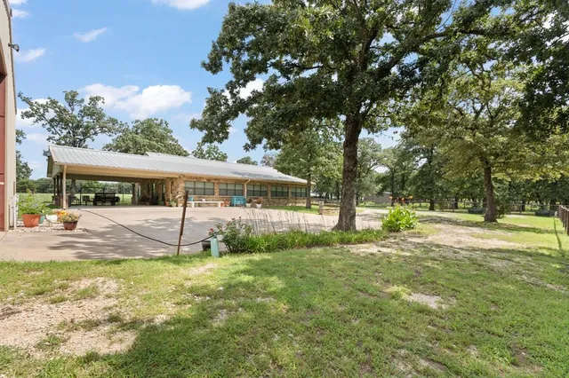 a house that has a big yard with large trees