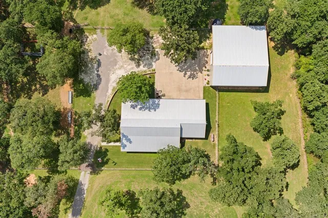 an aerial view of a house with a yard