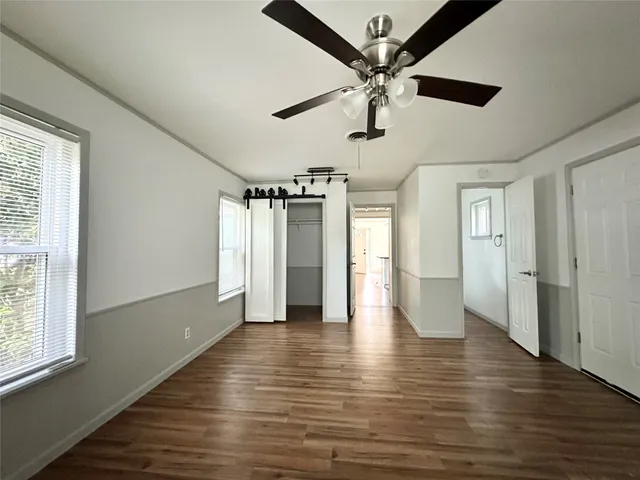 a view of an empty room with wooden floor