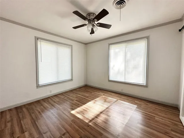 wooden floor in an empty room with a window