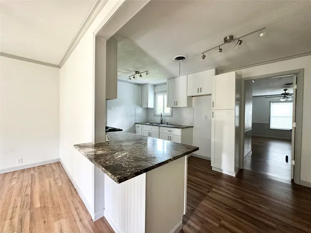 a kitchen with stainless steel appliances granite countertop a refrigerator a sink and a stove