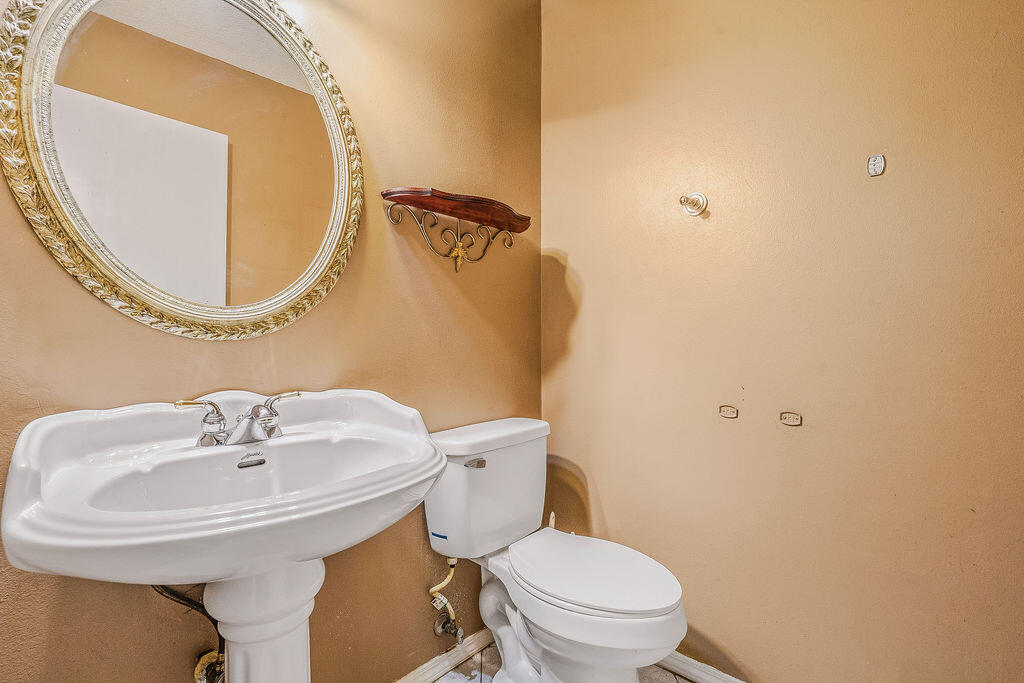 53 4th Street Shalimar, FL 32579 - Photo 31 of 47 a bathroom with a sink and a mirror