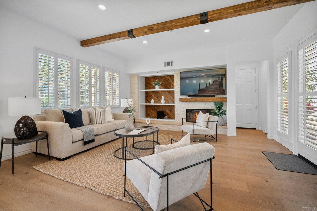 820 Jensen Court Encinitas, CA 92024 - Photo 3 of 30 a living room with fireplace furniture and a large window