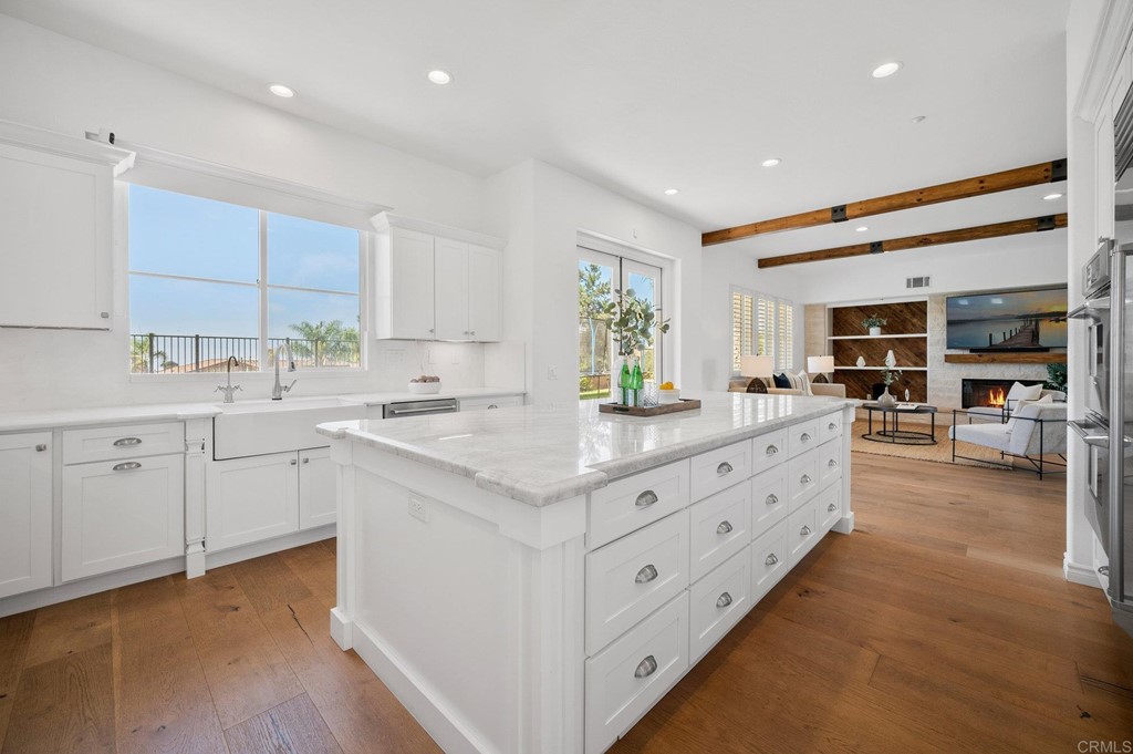 820 Jensen Court Encinitas, CA 92024 - Photo 8 of 30 a kitchen with sink stove and cabinets