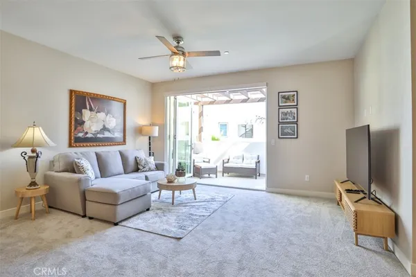 a dining room with furniture and a chandelier