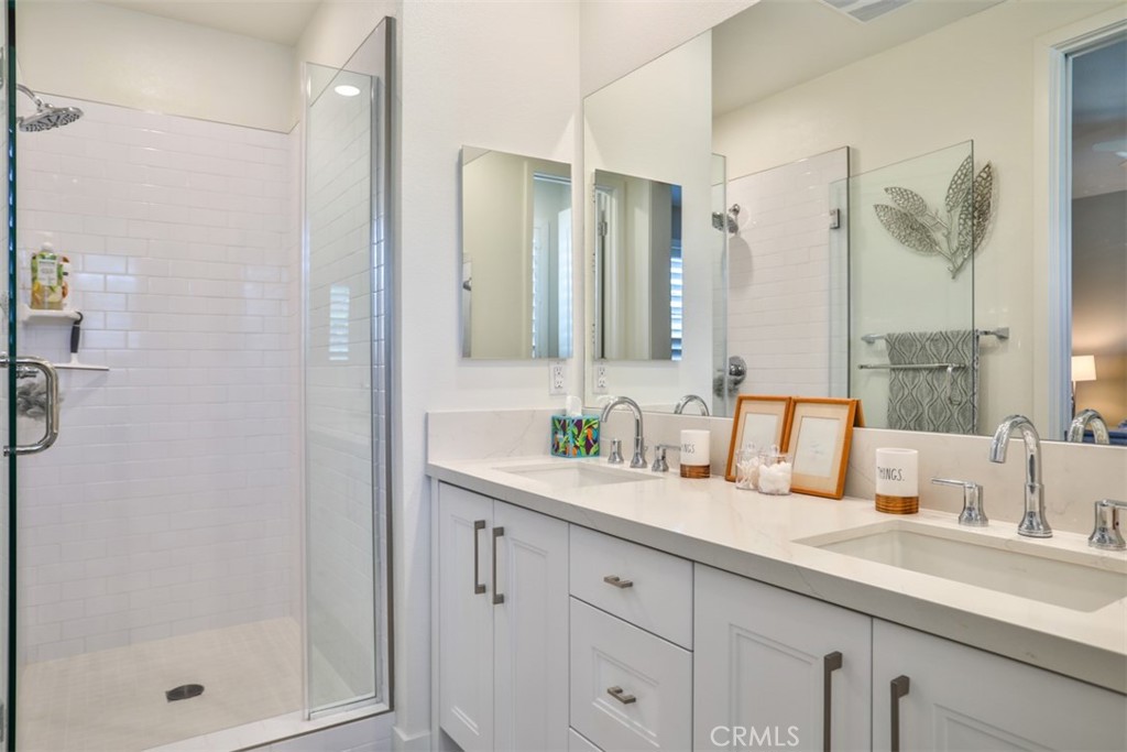 3318 Doheny Way Dana Point, CA 92629 - Photo 20 of 55 a bathroom with a shower sink and mirror