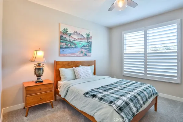 a bedroom with a bed and a lamp