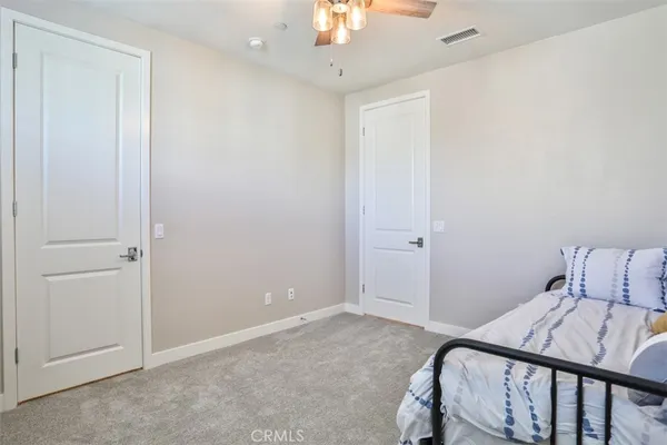 a view of bedroom with a bed and a chandelier fan