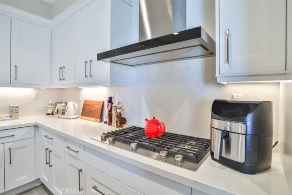 a kitchen with stainless steel appliances granite countertop a sink and a stove