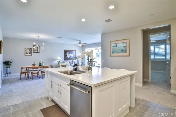 a kitchen with a sink a counter and chairs