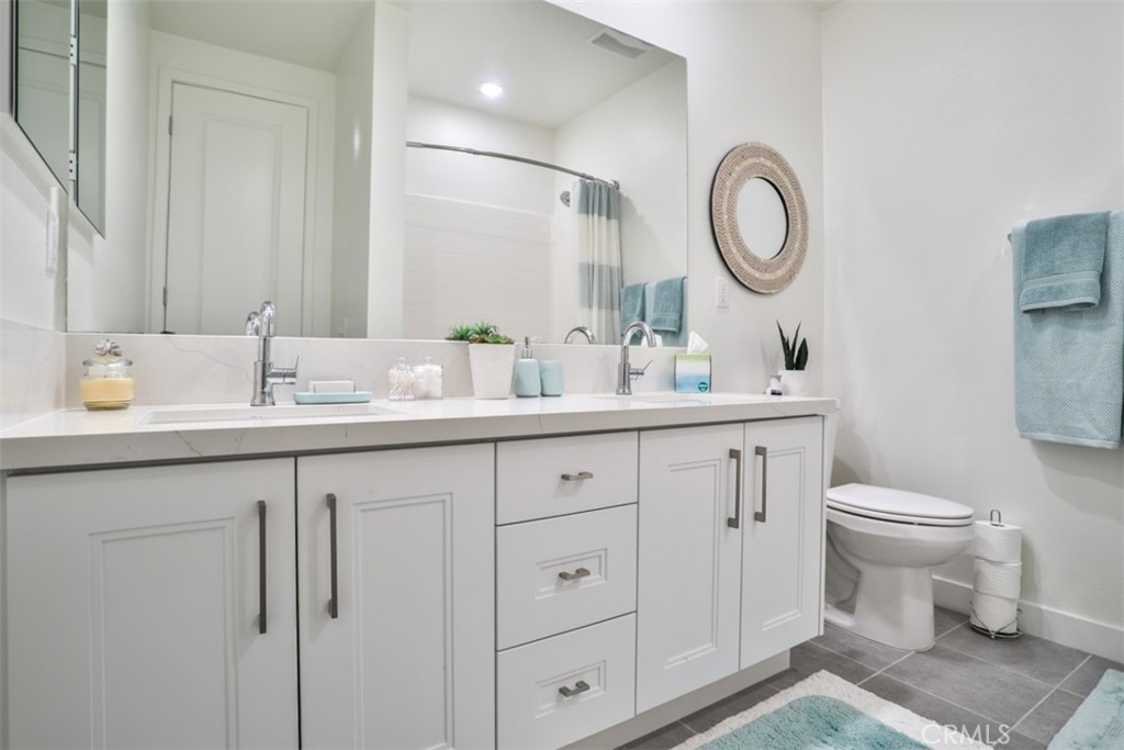 3318 Doheny Way Dana Point, CA 92629 - Photo 49 of 55 a bathroom with a toilet sink and mirror