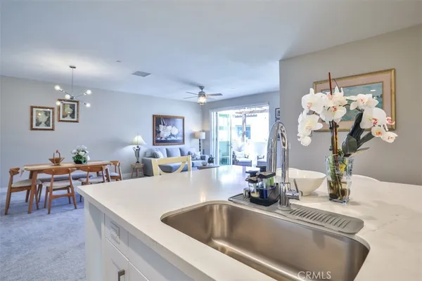 a kitchen with granite countertop stainless steel appliances white cabinets and a sink