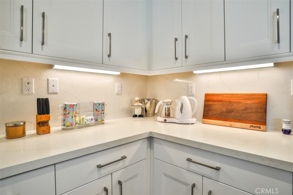 3318 Doheny Way Dana Point, CA 92629 - Photo 6 of 55 a kitchen with granite countertop stainless steel appliances white cabinets and a sink
