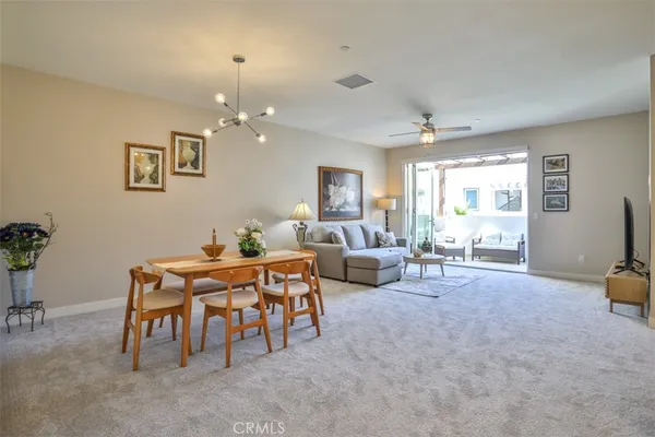 a view of a dining room with furniture and chandelier