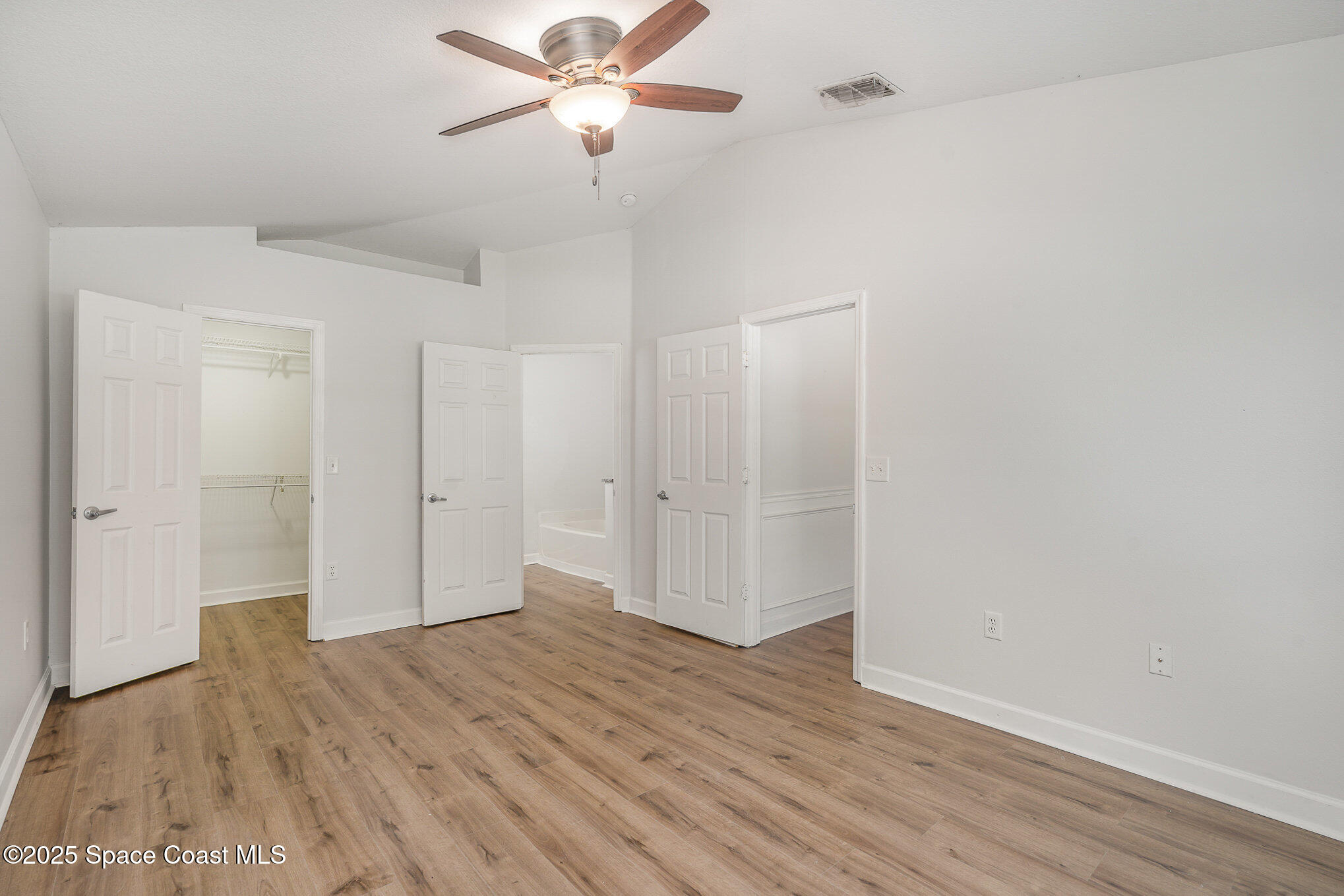 2143 Lansing Street Melbourne, FL 32935 - Photo 13 of 26 an empty room with wooden floor and windows