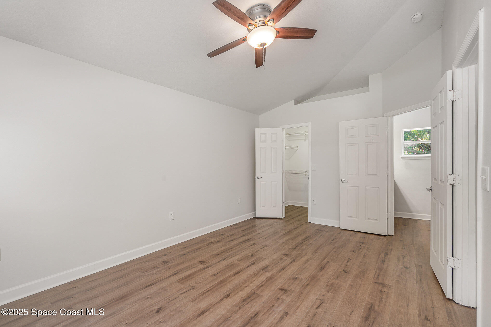 2143 Lansing Street Melbourne, FL 32935 - Photo 14 of 26 a view of empty room with wooden floor