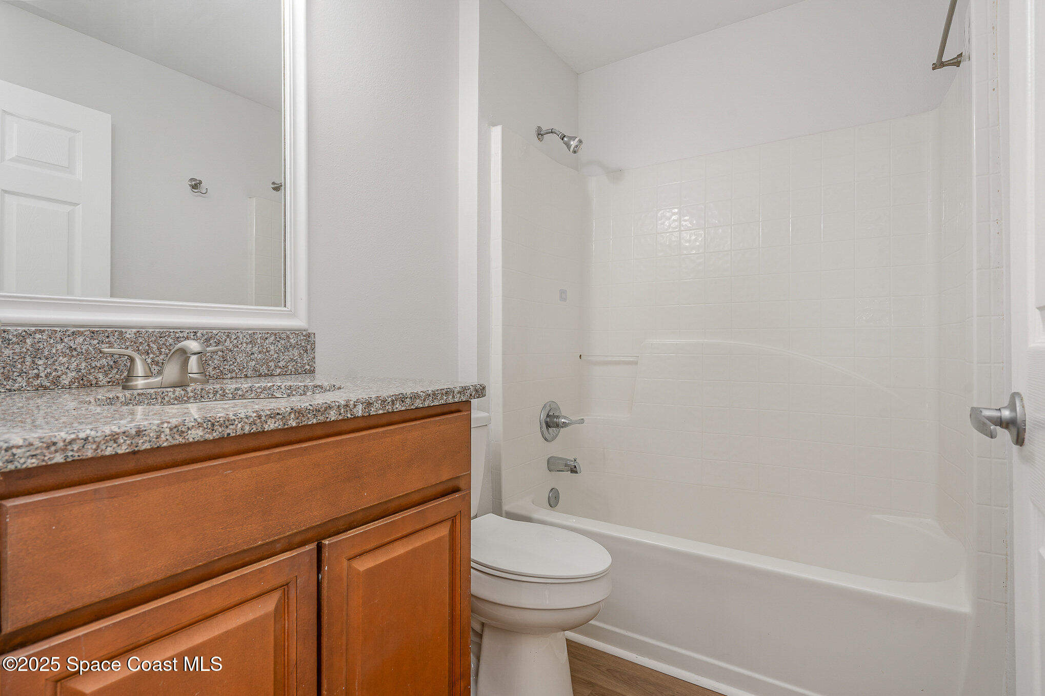 2143 Lansing Street Melbourne, FL 32935 - Photo 15 of 26 a bathroom with a granite countertop sink toilet and shower