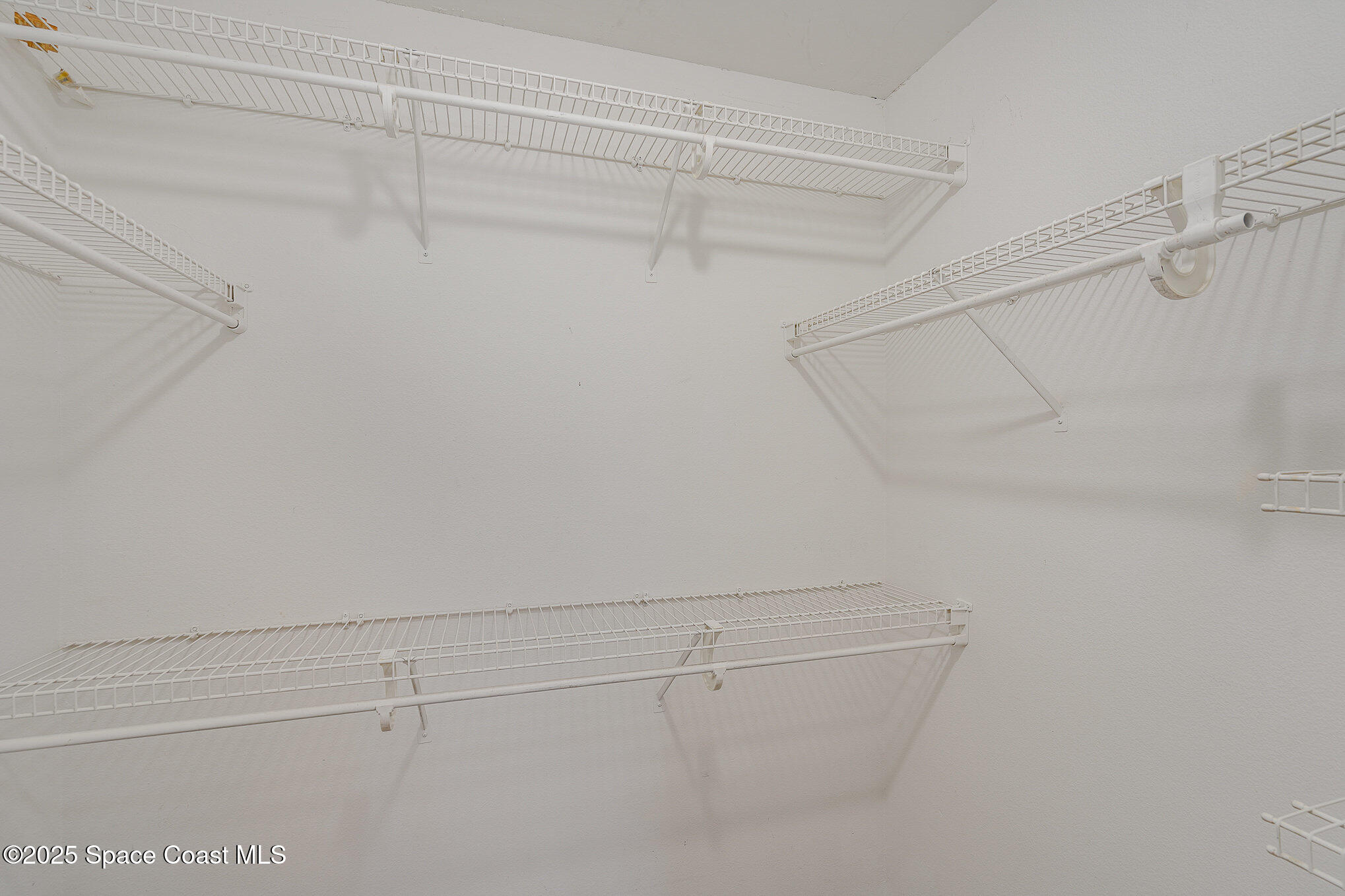 2143 Lansing Street Melbourne, FL 32935 - Photo 16 of 26 a view of a room with racks on the wall