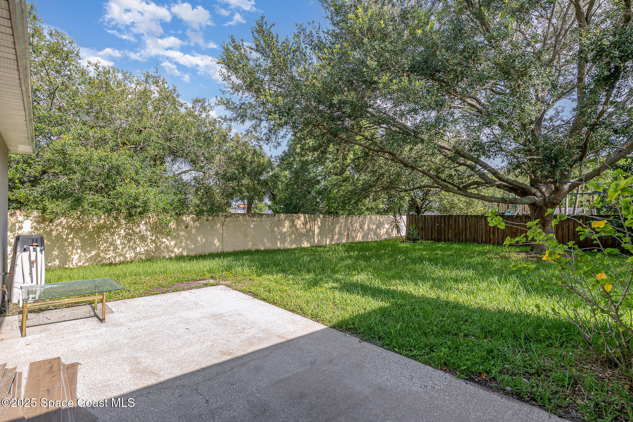 2143 Lansing Street Melbourne, FL 32935 - Photo 23 of 26 a view of a yard with large trees and a barn in it