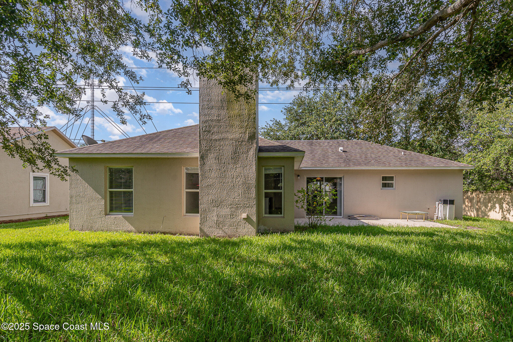 2143 Lansing Street Melbourne, FL 32935 - Photo 25 of 26 a view of a house with a yard and large tree
