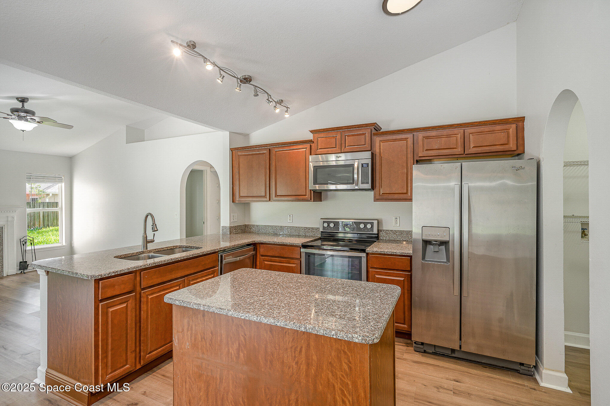2143 Lansing Street Melbourne, FL 32935 - Photo 10 of 26 a kitchen with stainless steel appliances granite countertop a sink stove and refrigerator