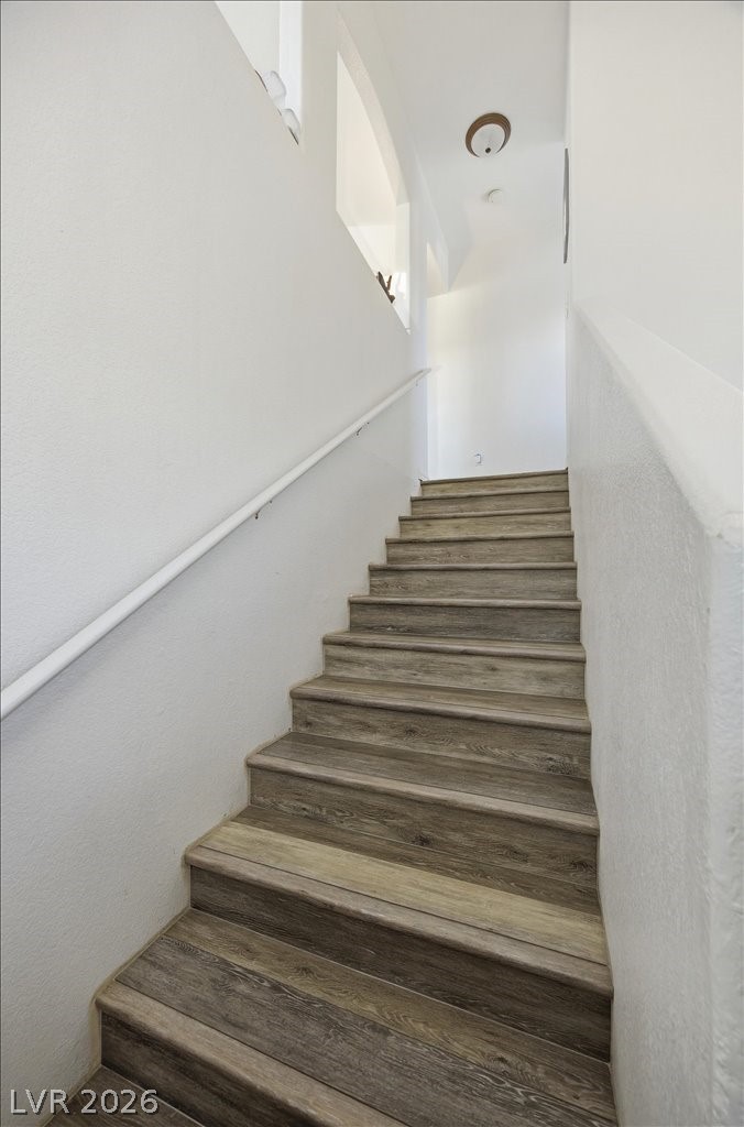 10550 West Alexander Road, Unit 2164 Las Vegas, NV 89129 - Photo 25 of 27 Hardwood stairs ascend to the next level, offering both durability and timeless appeal.