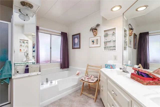 a bathroom with a tub sink and a mirror