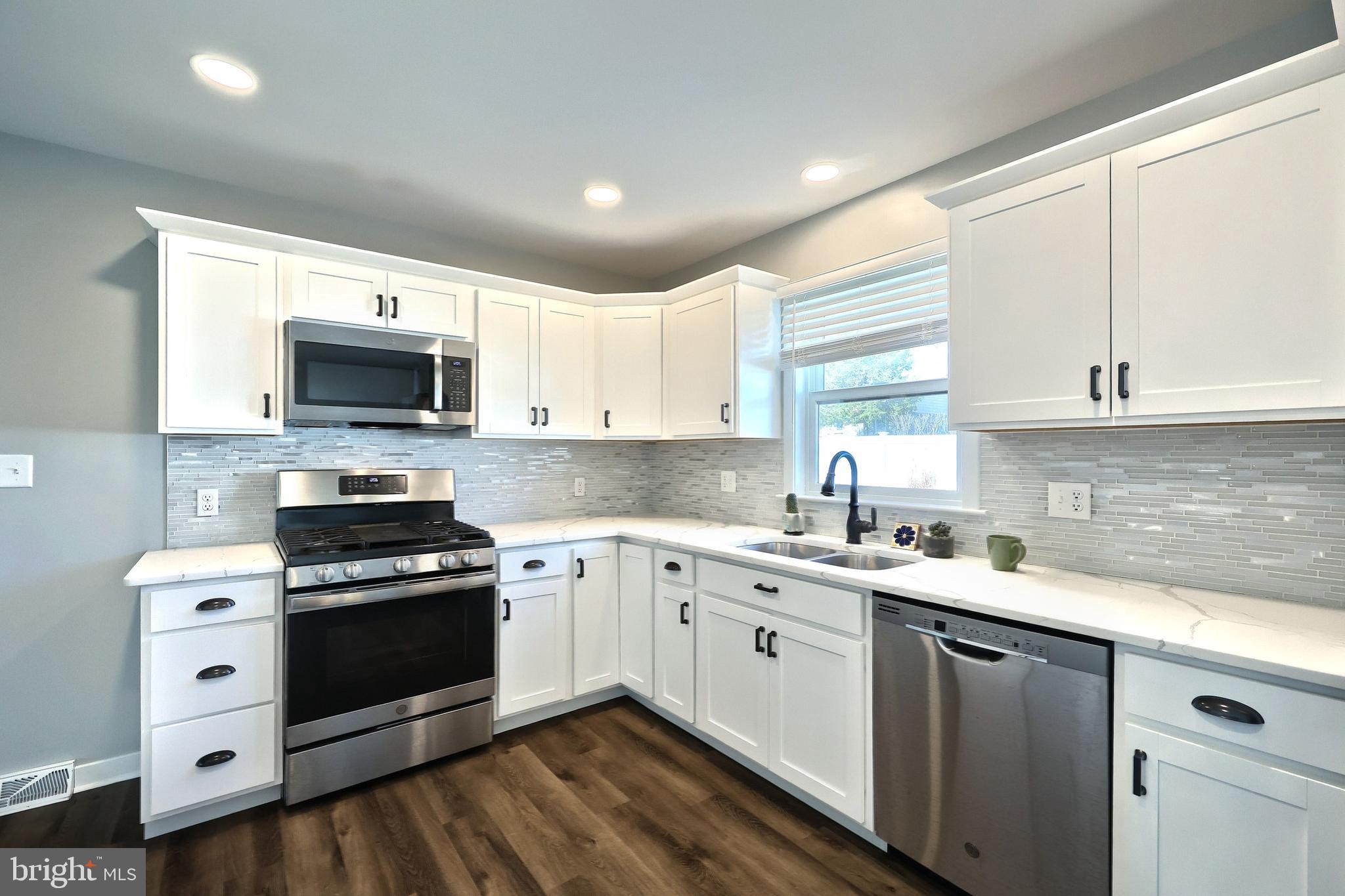 55 Cardinal Drive Hanover, PA 17331 - Photo 24 of 53 a kitchen with a sink stove top oven and cabinets