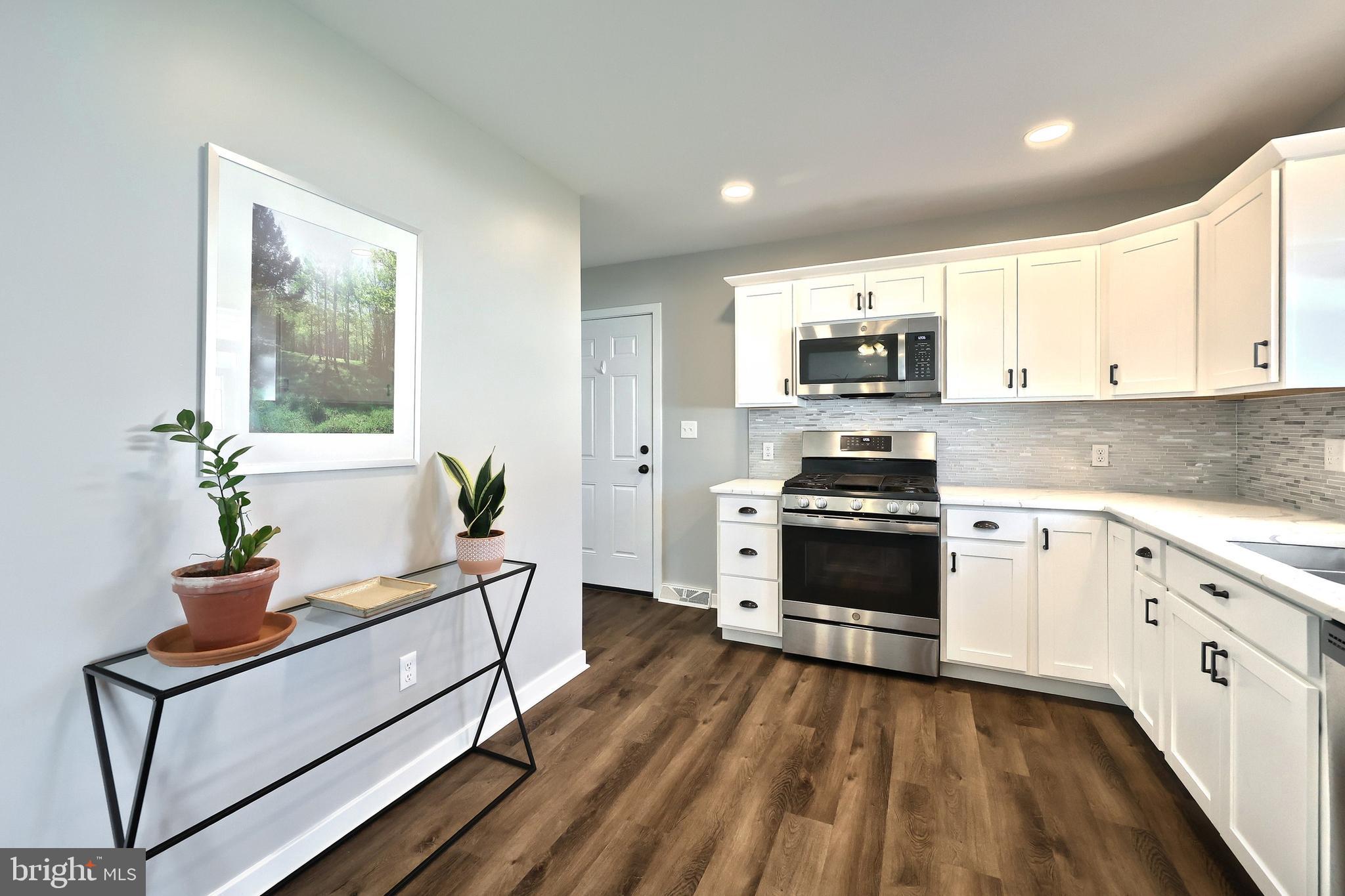 55 Cardinal Drive Hanover, PA 17331 - Photo 26 of 53 a kitchen with granite countertop a stove a sink and a microwave