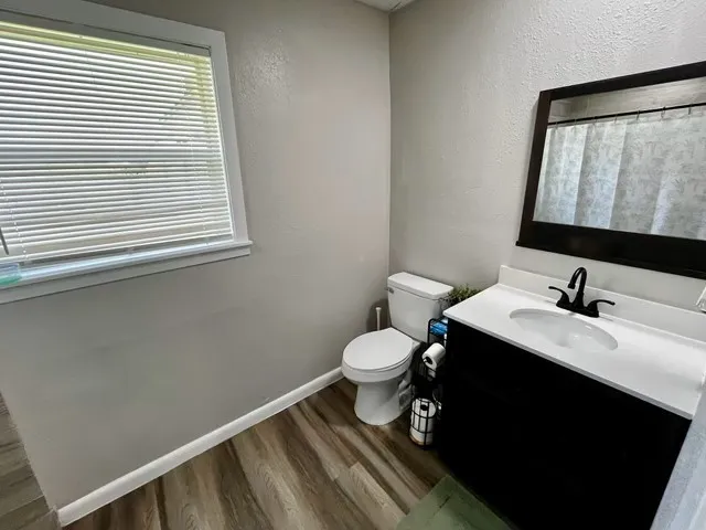 a bathroom with a toilet sink and mirror