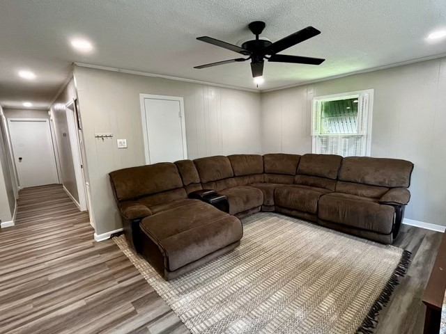 1409 20th Street Huntsville, TX 77340 - Photo 7 of 13 a living room with furniture and a wooden floor
