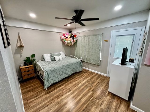 1409 20th Street Huntsville, TX 77340 - Photo 10 of 13 a bedroom with a bed a mirror and furniture