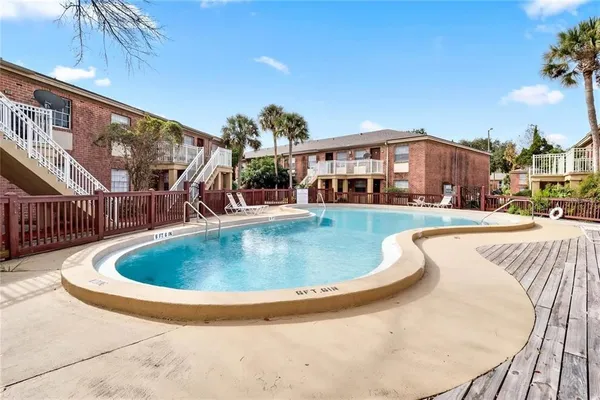 a view of a swimming pool with a patio