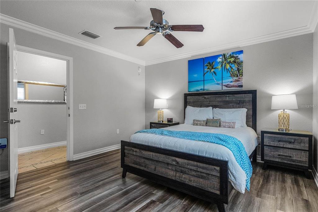 1102 Sunset View Circle, Unit 204 Reunion, FL 34747 - Photo 11 of 26 a bedroom with a bed and a chandelier