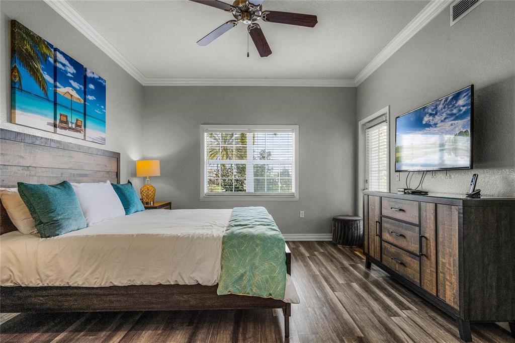 1102 Sunset View Circle, Unit 204 Reunion, FL 34747 - Photo 13 of 26 a bedroom with a bed and a flat screen tv