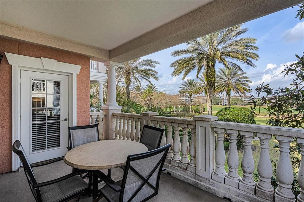 1102 Sunset View Circle, Unit 204 Reunion, FL 34747 - Photo 16 of 26 a view of a chairs and table in the balcony