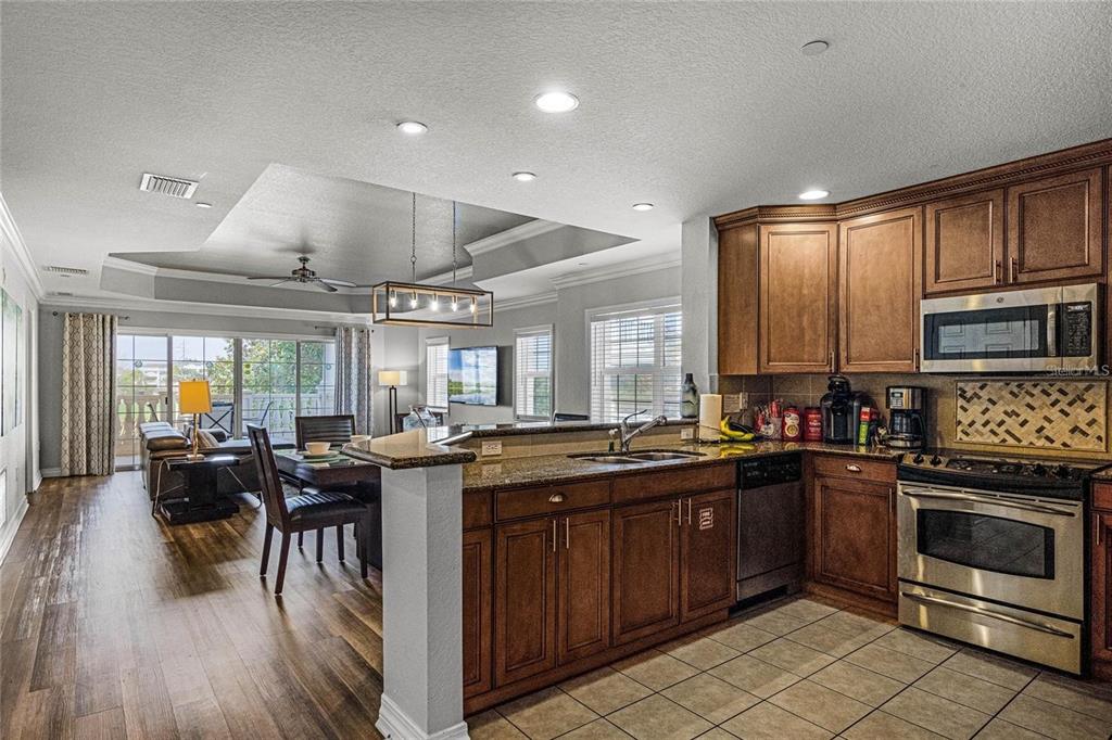 1102 Sunset View Circle, Unit 204 Reunion, FL 34747 - Photo 7 of 26 a kitchen with lots of counter top space and stainless steel appliances